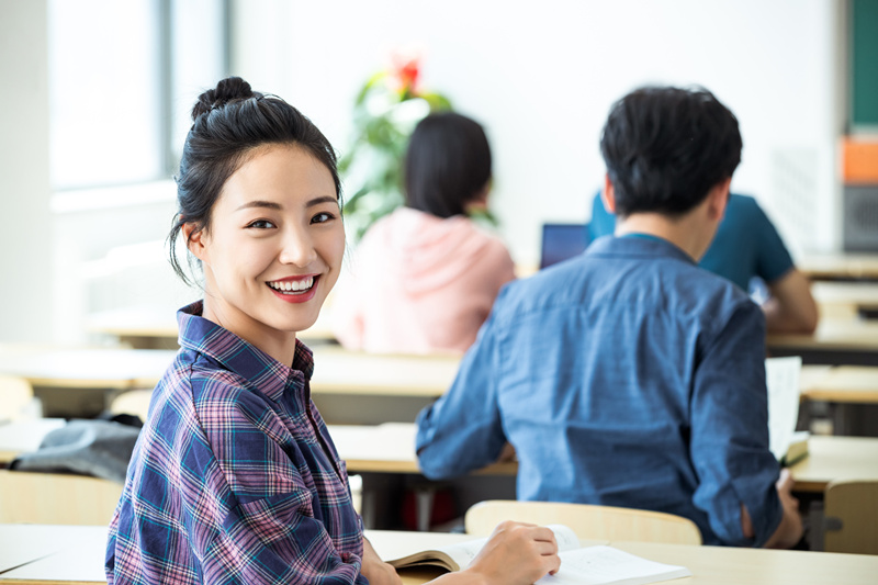 摄图网_501902626_欢乐青年女人大学生在教室内上?企业商用).jpg